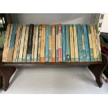 A table top bookcase with penguin and pelican books