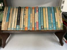 A table top bookcase with penguin and pelican books