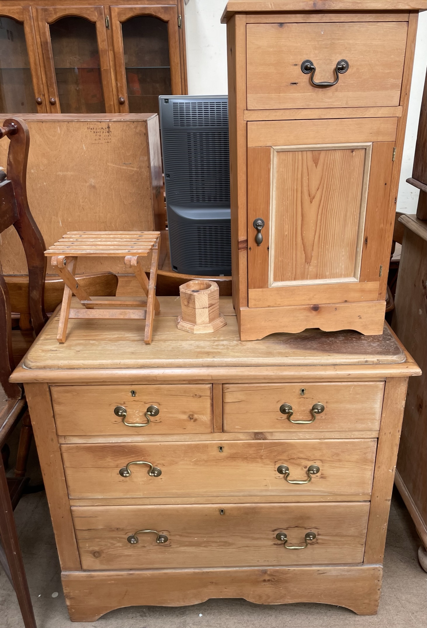 A pine chest with two short and two long drawers on a shaped base together with a pine bedside