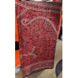 A large wool paisley shawl in reds and blues