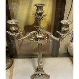 A large electroplated three branch candlestick on a trefoil base