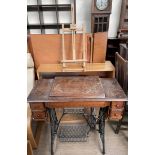 A Singer sewing machine table with cast iron base together with a bookcase and a table top easel