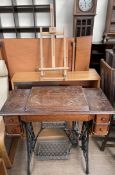 A Singer sewing machine table with cast iron base together with a bookcase and a table top easel