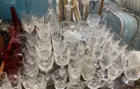 Crystal drinking glasses together with glass decanters,