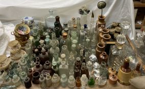 Assorted glass bottles together with stoneware bottles, glass decanters,