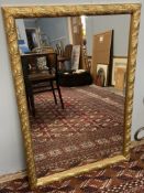 A gilt framed wall mirror decorated with leaves