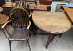 A 20th century oak gateleg dining table on barley twist legs,