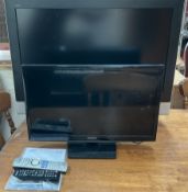 A Samsung 24" Led television, Model Number UE24H4003AW, with remote control and manual,
