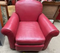 An early 20th century red leatherette arm chair