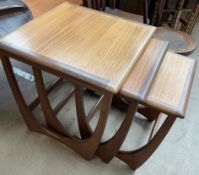 A G-Plan teak nest of three square tables