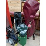 Two golf bags together with a golf trolley a ball bag, putting green,