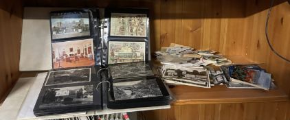 Two postcard albums together with loose postcards,