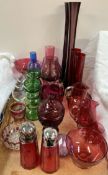 Assorted cranberry glass jugs,