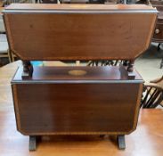 An Edwardian mahogany two tier Sutherland table on turned legs