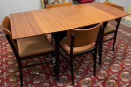 A mid 20th century teak and ebonised dining table and four chairs