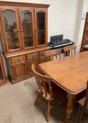 A modern dining table together with six chairs and a matching wall unit