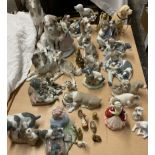 A collection of Lladro and Nao dog figures and figure groups together with a Royal Doulton figure,