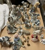 A collection of Lladro and Nao dog figures and figure groups together with a Royal Doulton figure,