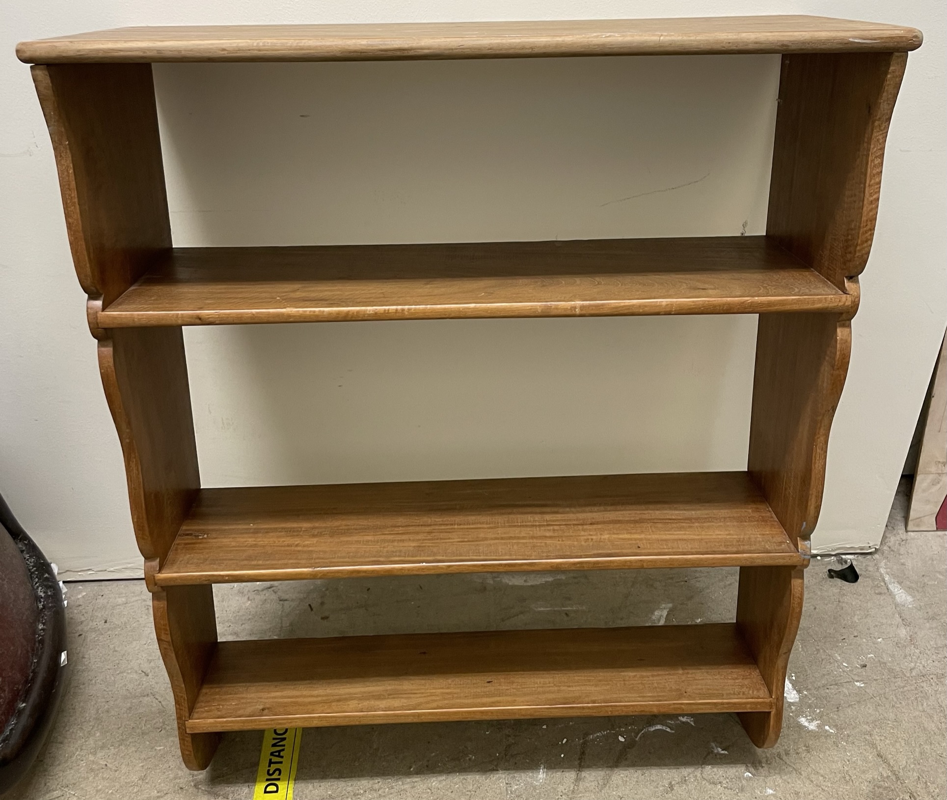 A mahogany waterfall bookcase with four shelves