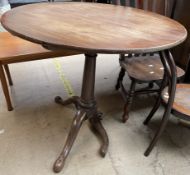 A 19th century mahogany tripod table with a bird cage action