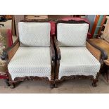 A pair of mahogany framed bergere single caned arm chairs with a carved front rail and claw and