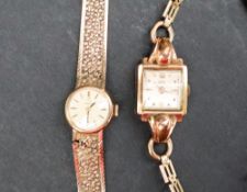 A lady's 9ct gold Omega wristwatch with a silvered dial and batons, on an integral strap,