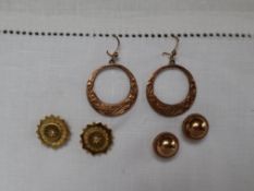 A pair of 9ct yellow gold domed earrings, together with a pair of 9ct gold hoop earrings,