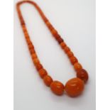 An amber bead necklace with graduated beads,