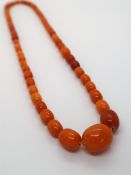 An amber bead necklace with graduated beads,