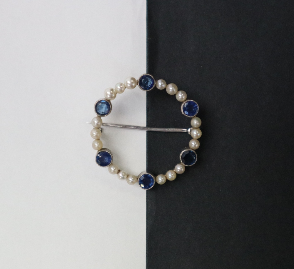 A sapphire and pearl brooch, of circular form set in white metal marked 9ct, approximately 3. - Image 3 of 6