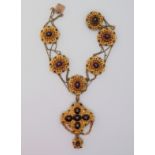A Victorian yellow metal necklace, of scrolling and bead form, set with cabochon garnets, diamonds,