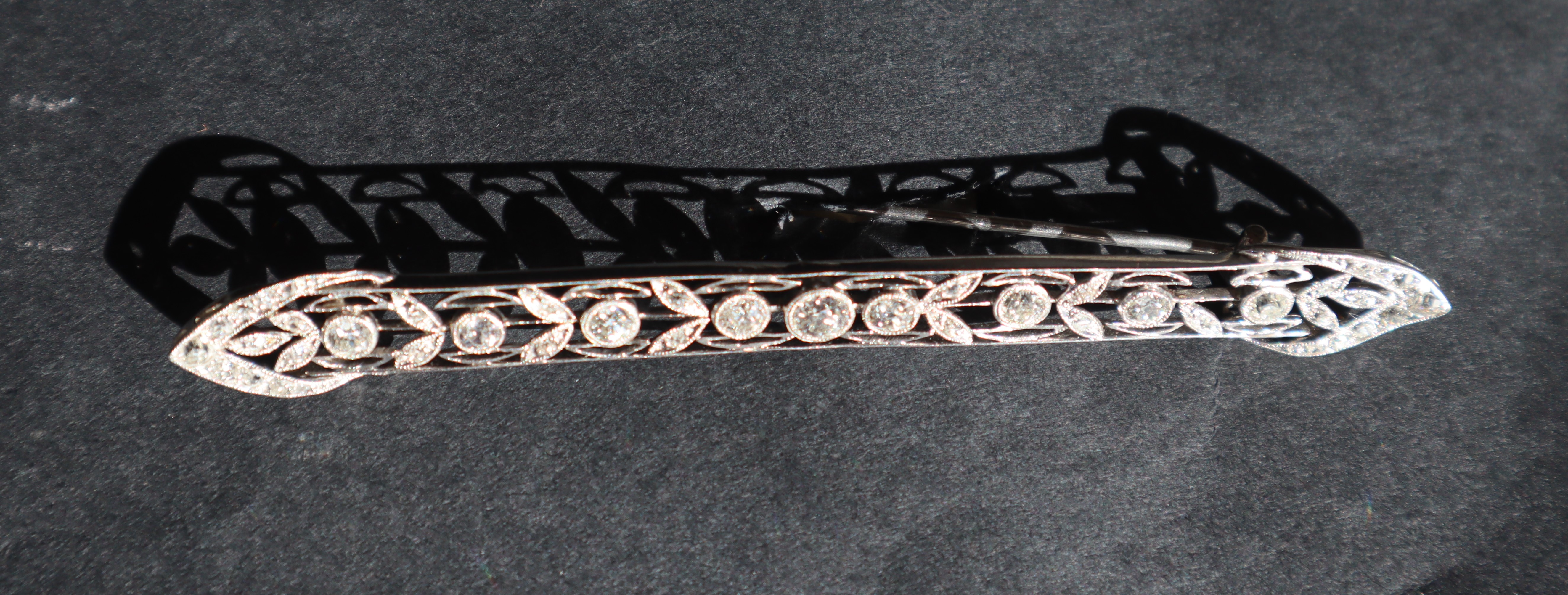 A Victorian diamond bar brooch, set with round old cut diamonds to a white metal wirework setting, - Image 5 of 6