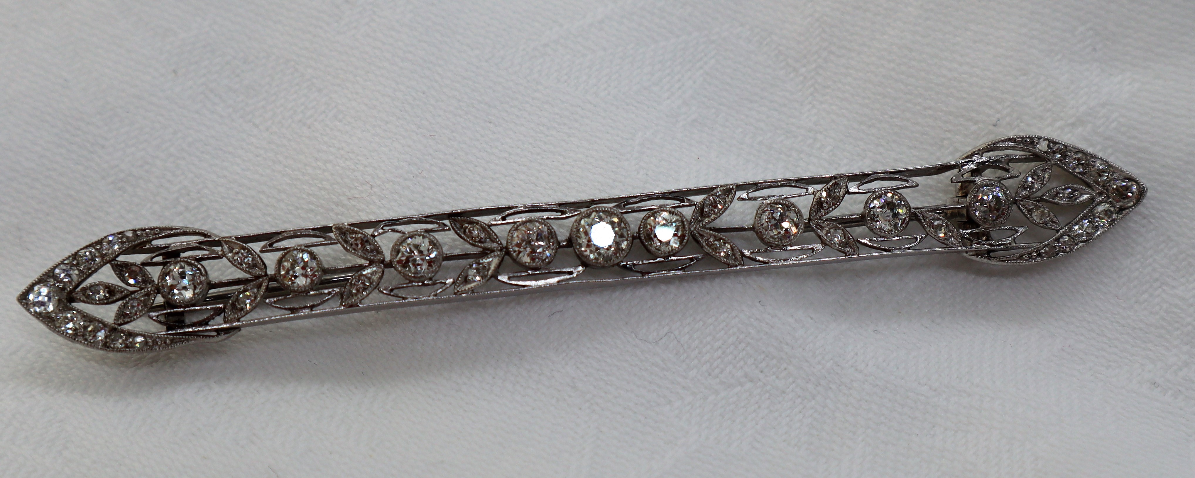 A Victorian diamond bar brooch, set with round old cut diamonds to a white metal wirework setting, - Image 2 of 6