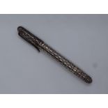 A silver roller ball pen, with body decorated with flat circular disks, marked 925,