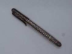 A silver roller ball pen, with body decorated with flat circular disks, marked 925,