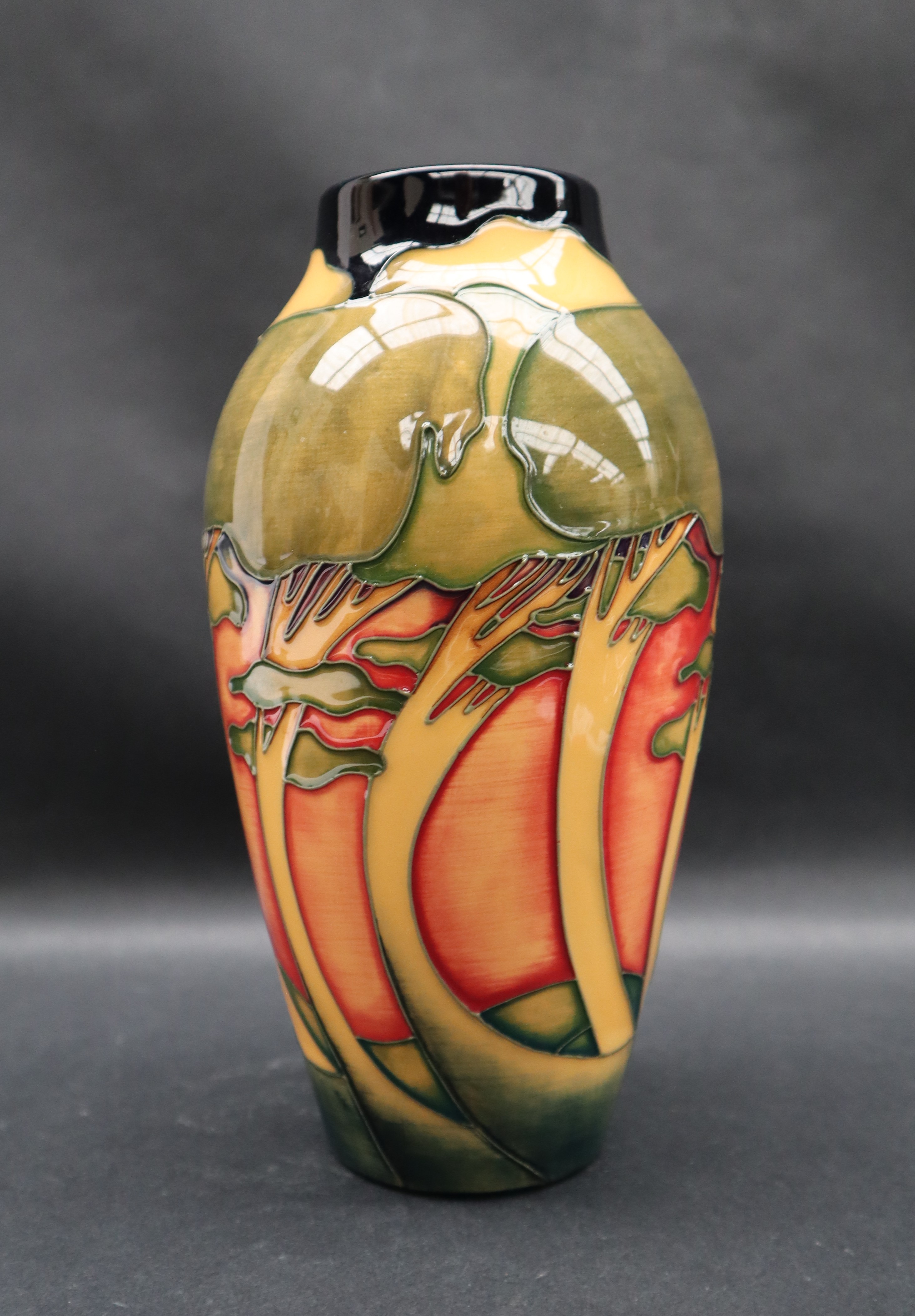 A Moorcroft pottery vase decorated with swaying trees to an orange ground, - Image 3 of 6