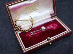 A diamond bar brooch, the round old cut diamond approximately 0.