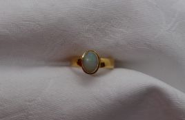 A 22ct yellow gold ring, set with an opal, size M 1/2, approximately 4.