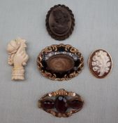 A gold plated mourning brooch with central panel of hair,