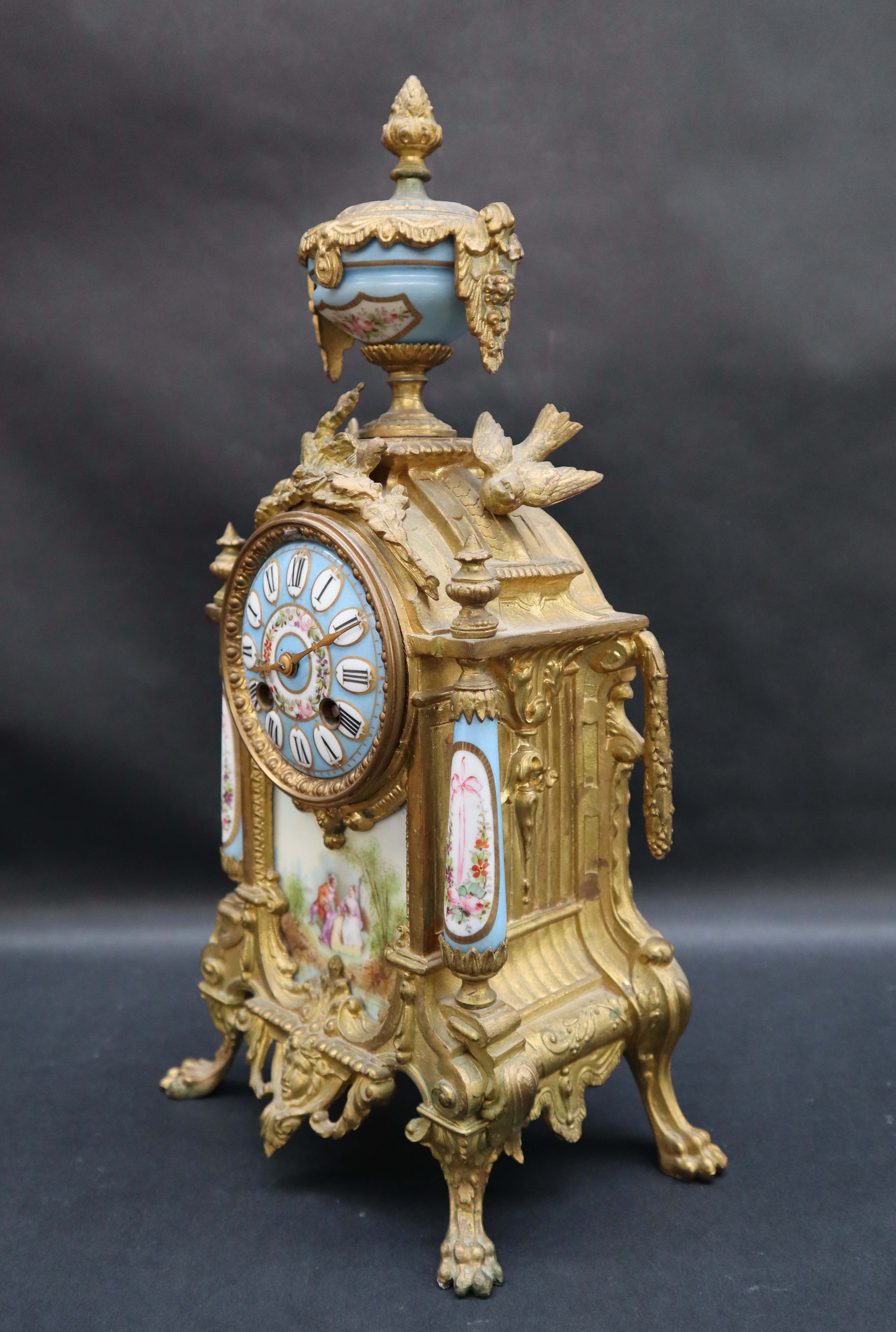 A 19th century French ormolu clock with a porcelain urn surmount, - Image 2 of 5