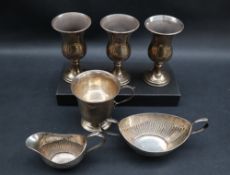 A set of three Elizabeth II silver goblets, with a flared rim and baluster body on a spreading foot,