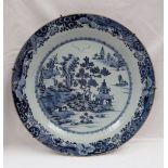 A Chinese porcelain blue and white charger, with a butterfly and scrolling border,