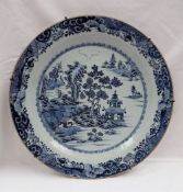 A Chinese porcelain blue and white charger, with a butterfly and scrolling border,