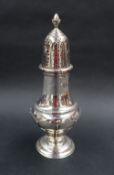 A George V silver sugar caster with an acorn finial and pierced domed cover and a line decorated