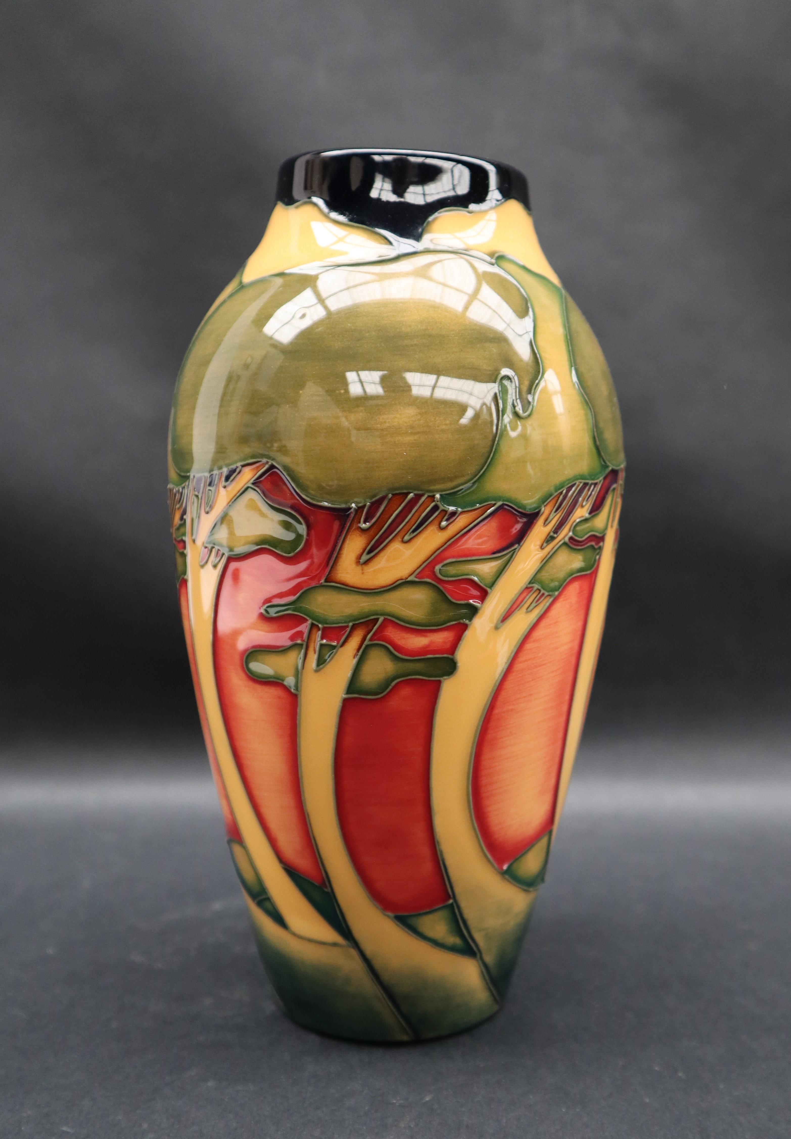 A Moorcroft pottery vase decorated with swaying trees to an orange ground, - Image 4 of 6