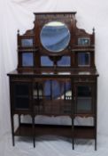 An Edwardian mahogany chiffonier, with a central circular mirror, other mirrors and shelves,