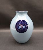 A Moorcroft pottery vase decorated with royal blue vignettes of flowers and leaves to a light blue