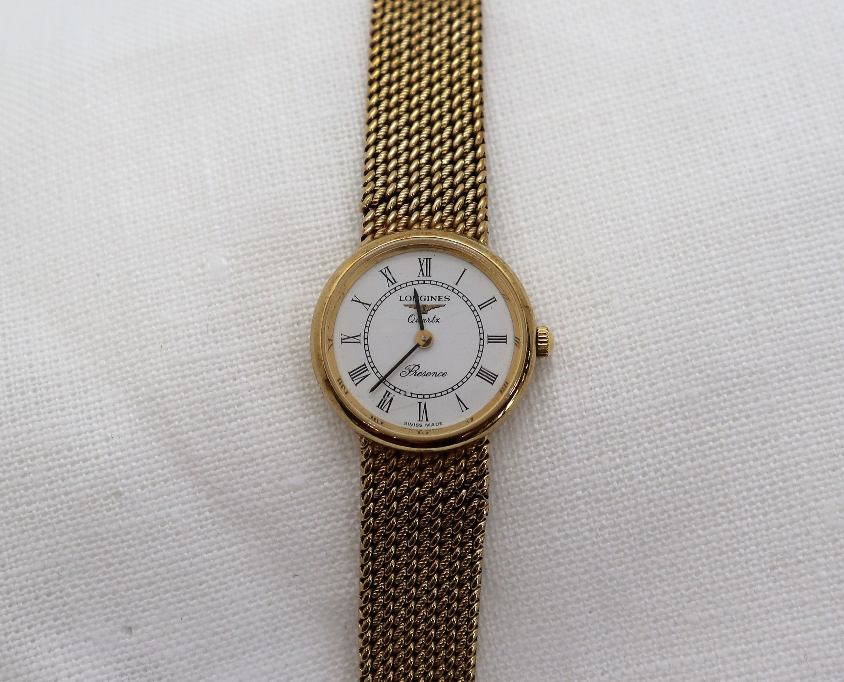 A lady's 9ct yellow gold Longines Presence wristwatch, with a circular dial and Roman numerals,