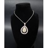 A diamond pendant set with a central fancy yellow pear shaped diamond approximately 12mm x 8mm