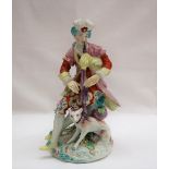 A Derby porcelain figure seated playing bagpipes with a dog at his feet on a circular base, 19.